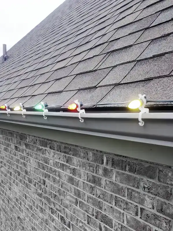 C7 bulbs lit along a gutter line, each one held in its own clip